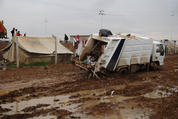 Garbage truck stuck in mud in Domiz Refugee Camp for Syrians, Iraq